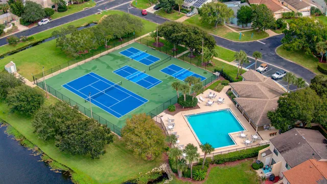 an aerial view of a tennis ground and a yard