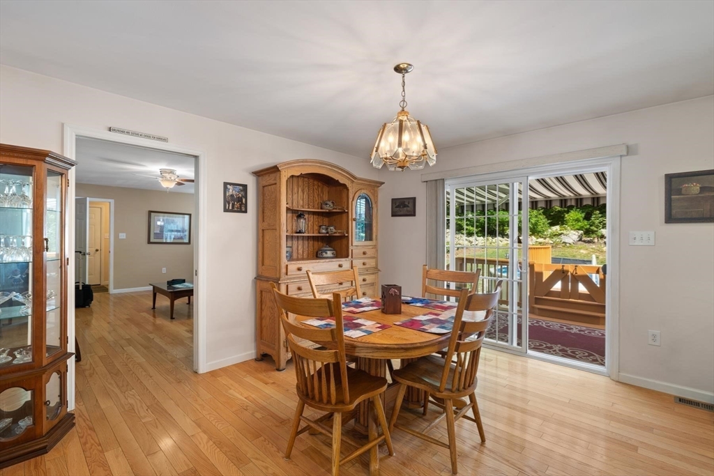 297 Manchaug Road Sutton, MA 01590 - Photo 12 of 40 a view of a dining room with furniture window and wooden floor