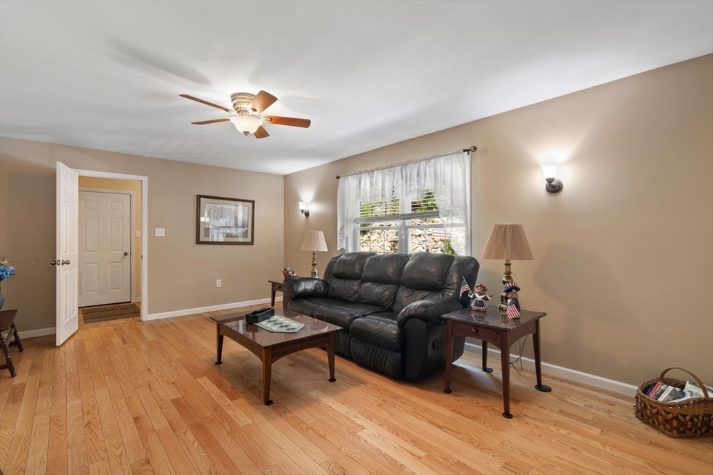 297 Manchaug Road Sutton, MA 01590 - Photo 13 of 40 a living room with furniture and a wooden floor