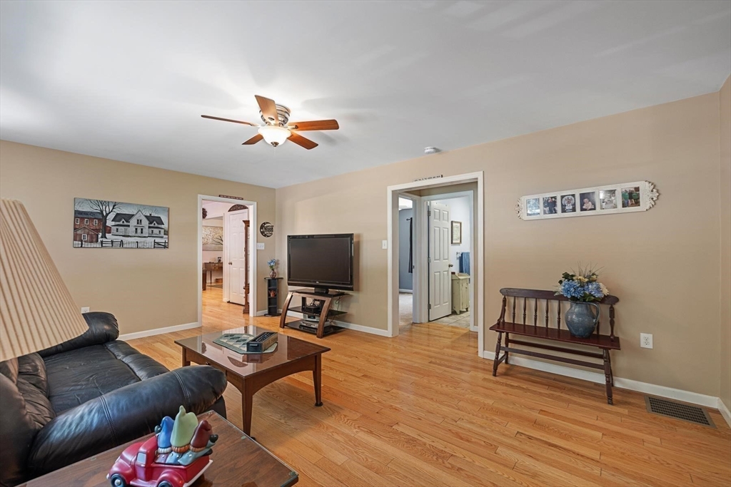 297 Manchaug Road Sutton, MA 01590 - Photo 14 of 40 a living room with furniture and a flat screen tv