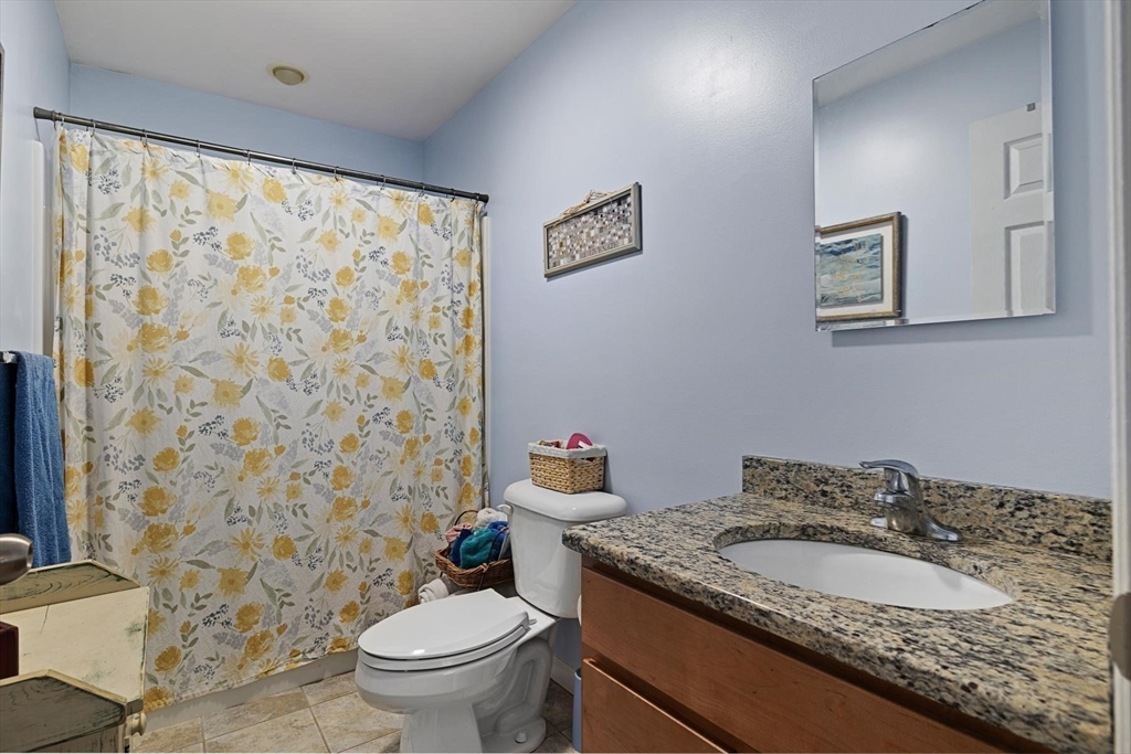 297 Manchaug Road Sutton, MA 01590 - Photo 16 of 40 a bathroom with a granite countertop sink toilet and a mirror