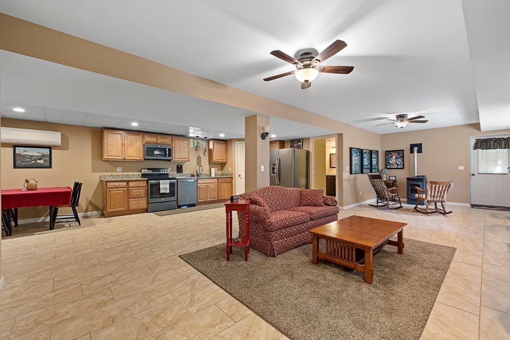 297 Manchaug Road Sutton, MA 01590 - Photo 19 of 40 a living room with furniture and kitchen view