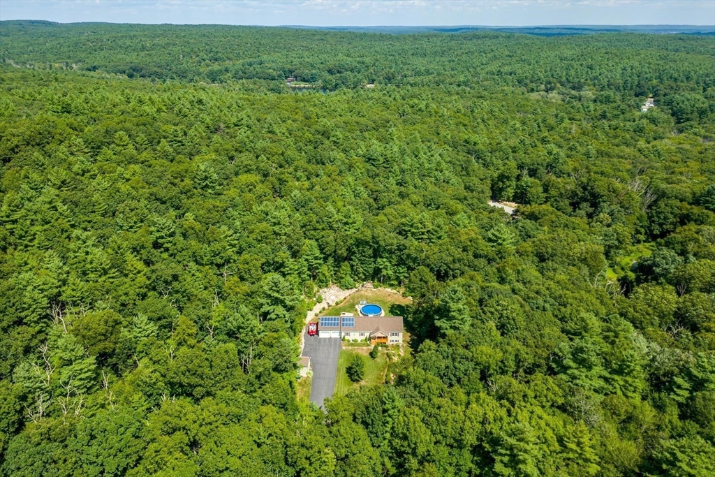 297 Manchaug Road Sutton, MA 01590 - Photo 2 of 40 a view of a lush green field