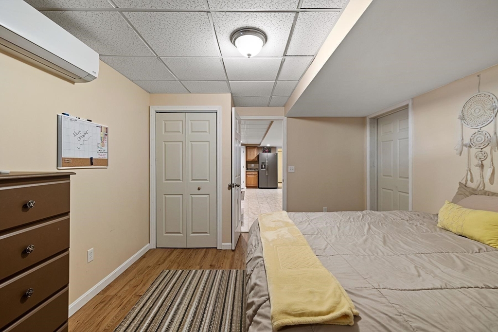 297 Manchaug Road Sutton, MA 01590 - Photo 25 of 40 a bedroom with a bed and a walk in closet