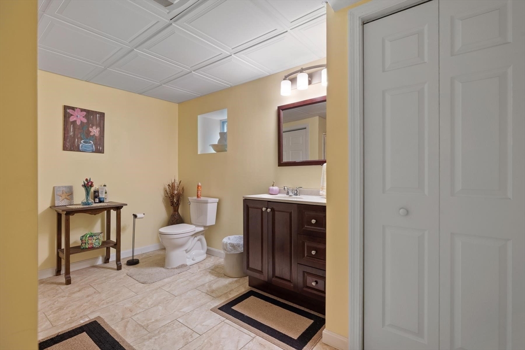 297 Manchaug Road Sutton, MA 01590 - Photo 26 of 40 a bathroom with a toilet a sink and mirror