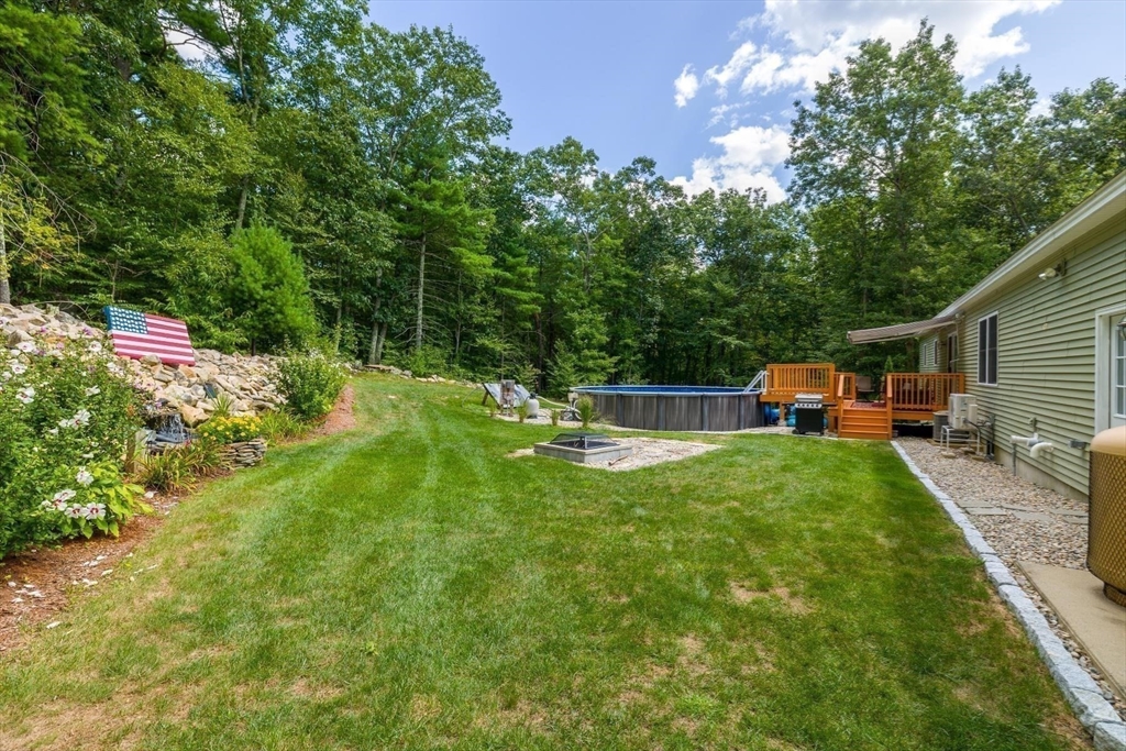 297 Manchaug Road Sutton, MA 01590 - Photo 29 of 40 a view of a house with backyard and sitting area