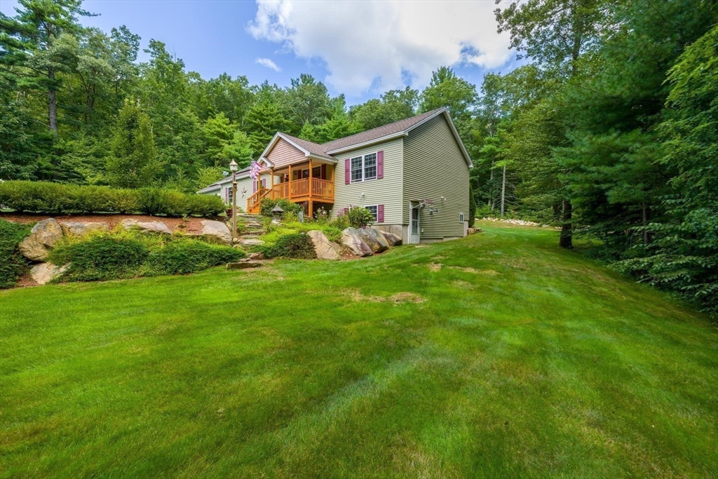 297 Manchaug Road Sutton, MA 01590 - Photo 31 of 40 a front view of house with yard and green space