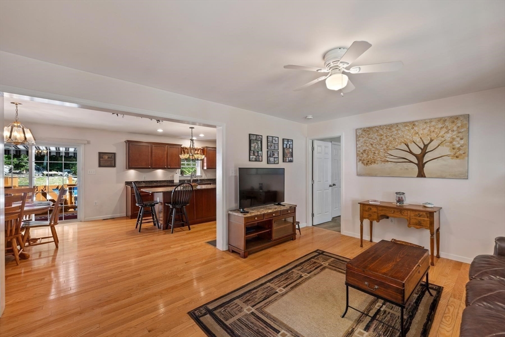 297 Manchaug Road Sutton, MA 01590 - Photo 5 of 40 a living room with furniture and a flat screen tv