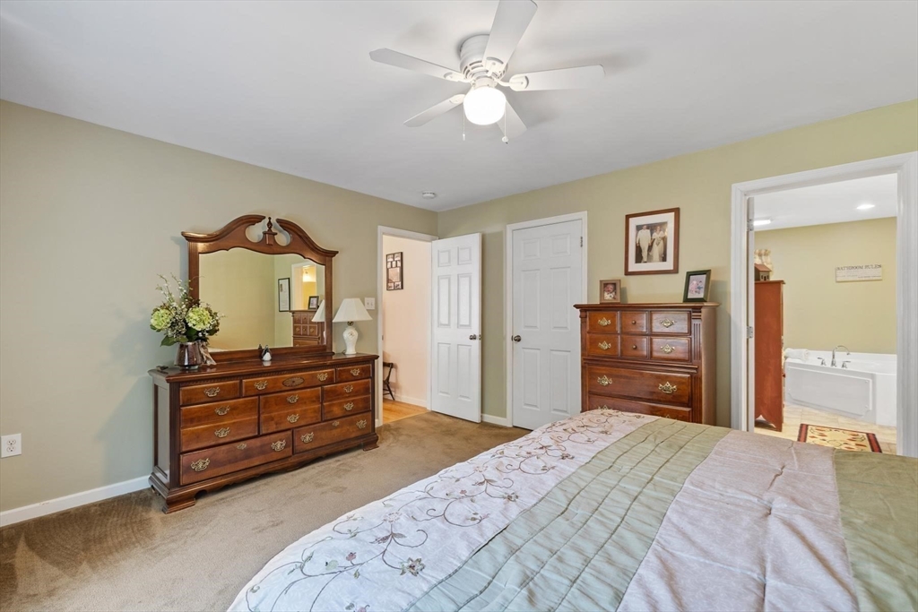 297 Manchaug Road Sutton, MA 01590 - Photo 7 of 40 a bedroom with a bed and a dresser