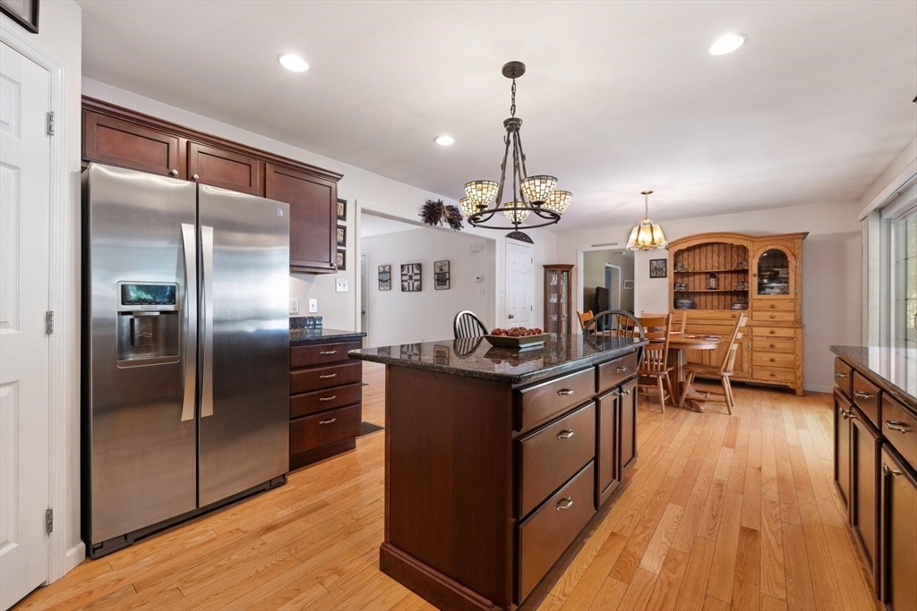 297 Manchaug Road Sutton, MA 01590 - Photo 10 of 40 a kitchen with stainless steel appliances granite countertop a stove and refrigerator