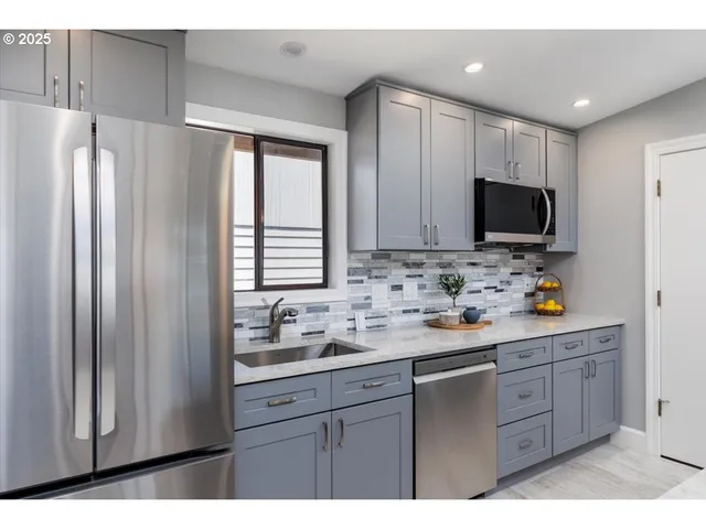 a kitchen with a refrigerator and a sink