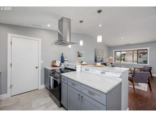a kitchen with a sink a stove and chairs