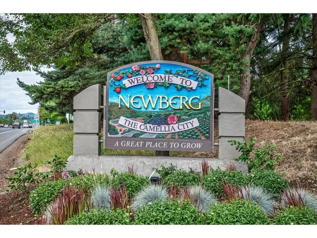 a bench sitting in front of flowers and trees