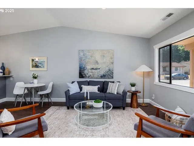 a living room with furniture and a large window