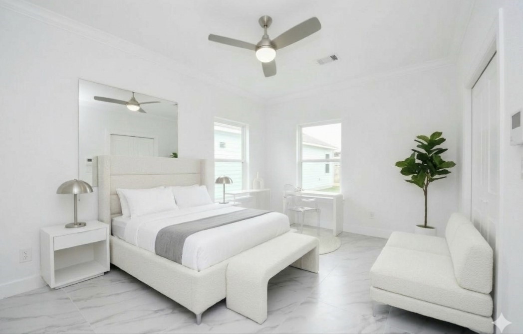 8312 Comal Street Houston, TX 77051 - Photo 7 of 17 a bedroom with a white bed and a chandelier