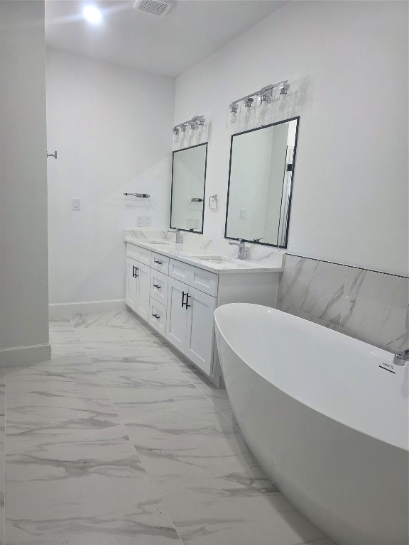 8312 Comal Street Houston, TX 77051 - Photo 8 of 17 a spacious bathroom with a bathtub and a double vanity sink