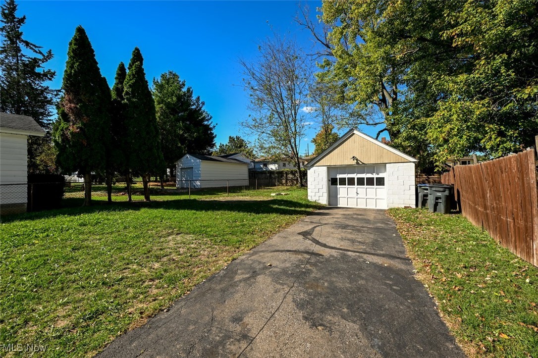 364 Stanley Road Akron, OH 44312 - Photo 4 of 29 View of yard with driveway, a detached garage, and an outdoor structure