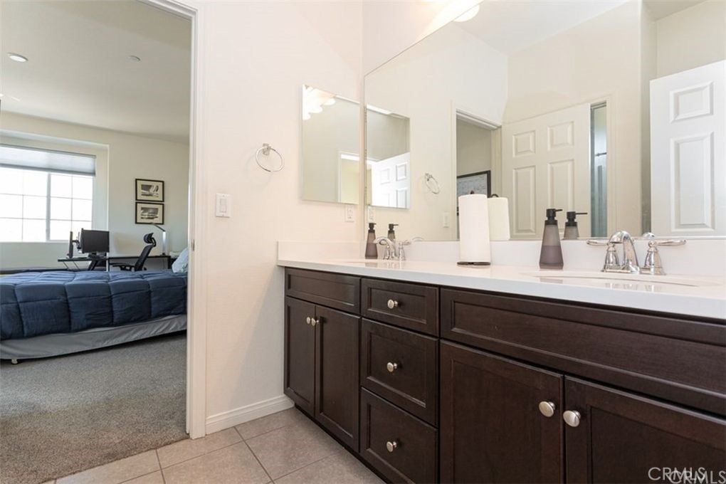 24125 Montecito Drive Wildomar, CA 92595 - Photo 12 of 25 a bathroom with a sink double vanity and a mirror