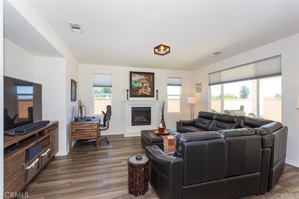 24125 Montecito Drive Wildomar, CA 92595 - Photo 15 of 25 a living room with furniture windows and a fireplace