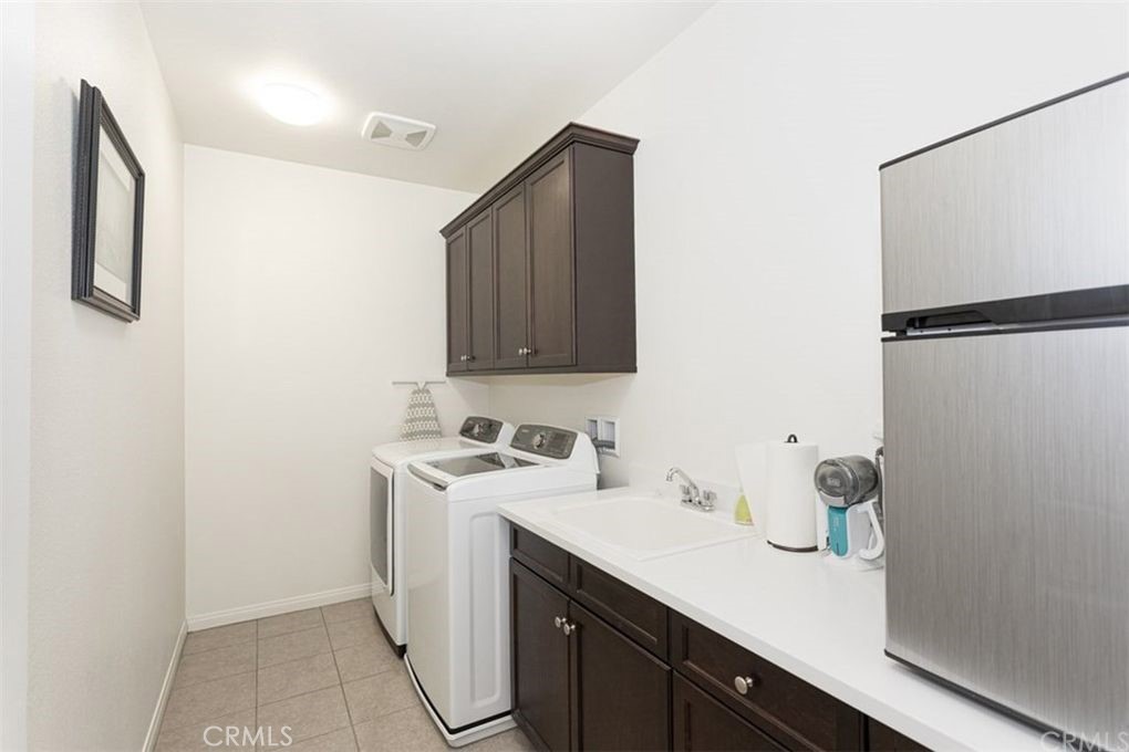 24125 Montecito Drive Wildomar, CA 92595 - Photo 16 of 25 a utility room with sink dryer and washer