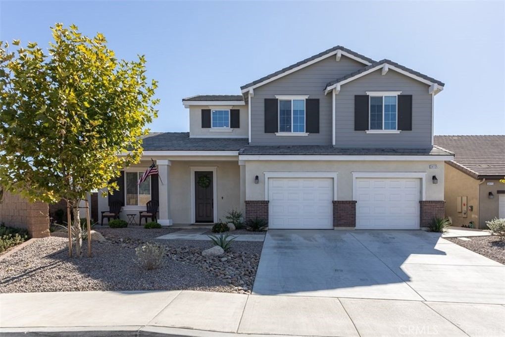 24125 Montecito Drive Wildomar, CA 92595 - Photo 19 of 25 a front view of a house with a yard and garage