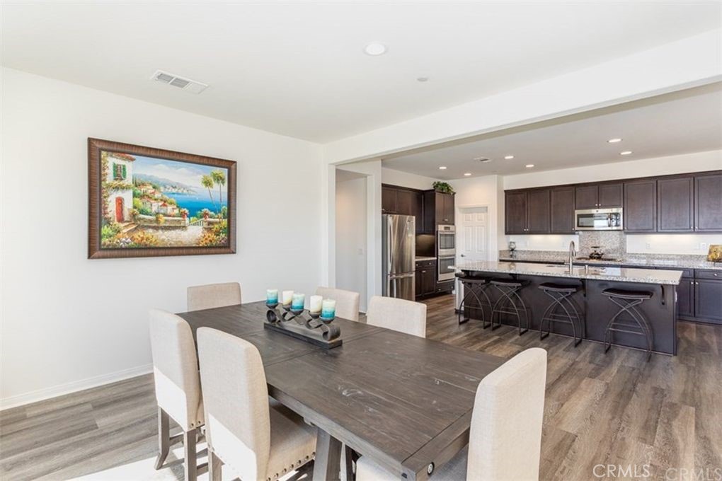 24125 Montecito Drive Wildomar, CA 92595 - Photo 8 of 25 a kitchen with a table and chairs in it