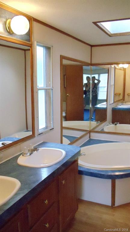 1766 North Ingleside Farm Road Iron Station, NC 28080 - Photo 11 of 23 a bathroom with a sink and a mirror