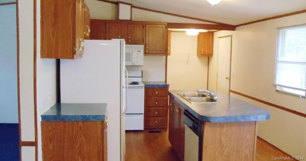 1766 North Ingleside Farm Road Iron Station, NC 28080 - Photo 15 of 23 a kitchen with stainless steel appliances a refrigerator and a stove