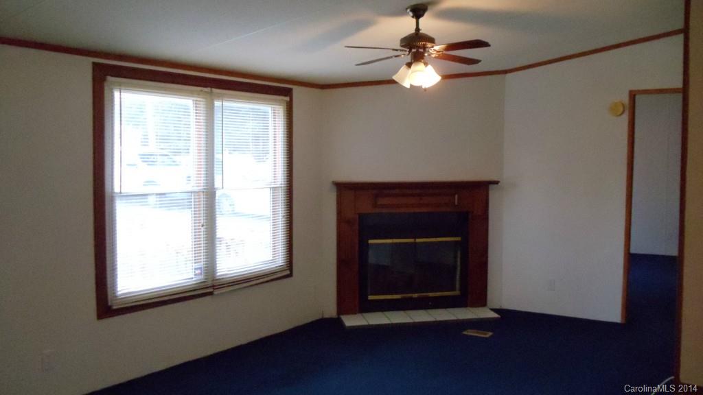 1766 North Ingleside Farm Road Iron Station, NC 28080 - Photo 4 of 23 a living room with a fireplace and a window