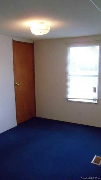 1766 North Ingleside Farm Road Iron Station, NC 28080 - Photo 5 of 23 an empty room with wooden floor and windows