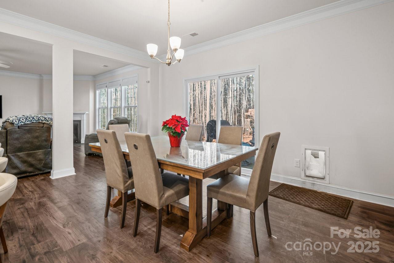 313 Streamwood Road Troutman, NC 28166 - Photo 14 of 48 a view of a dining room with furniture and wooden floor