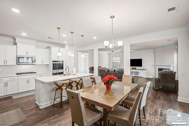 a view of kitchen with cabinets table and chairs