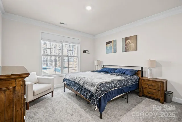 a bedroom with a bed a couch and a window