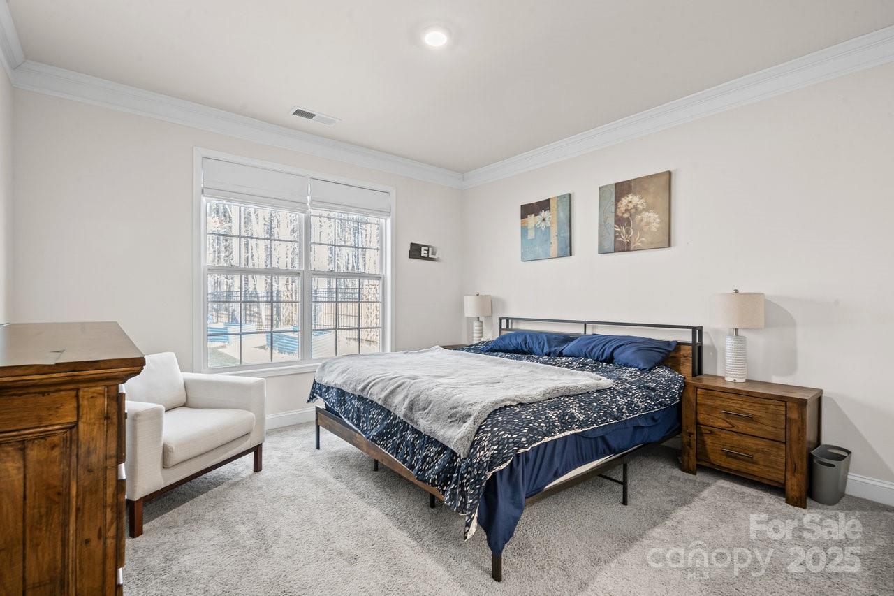 313 Streamwood Road Troutman, NC 28166 - Photo 21 of 48 a bedroom with a bed a couch and a window