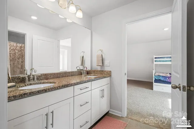 a bathroom with a double vanity sink and a mirror