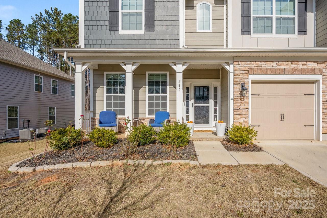 313 Streamwood Road Troutman, NC 28166 - Photo 3 of 48 front view of a brick house with potted plants