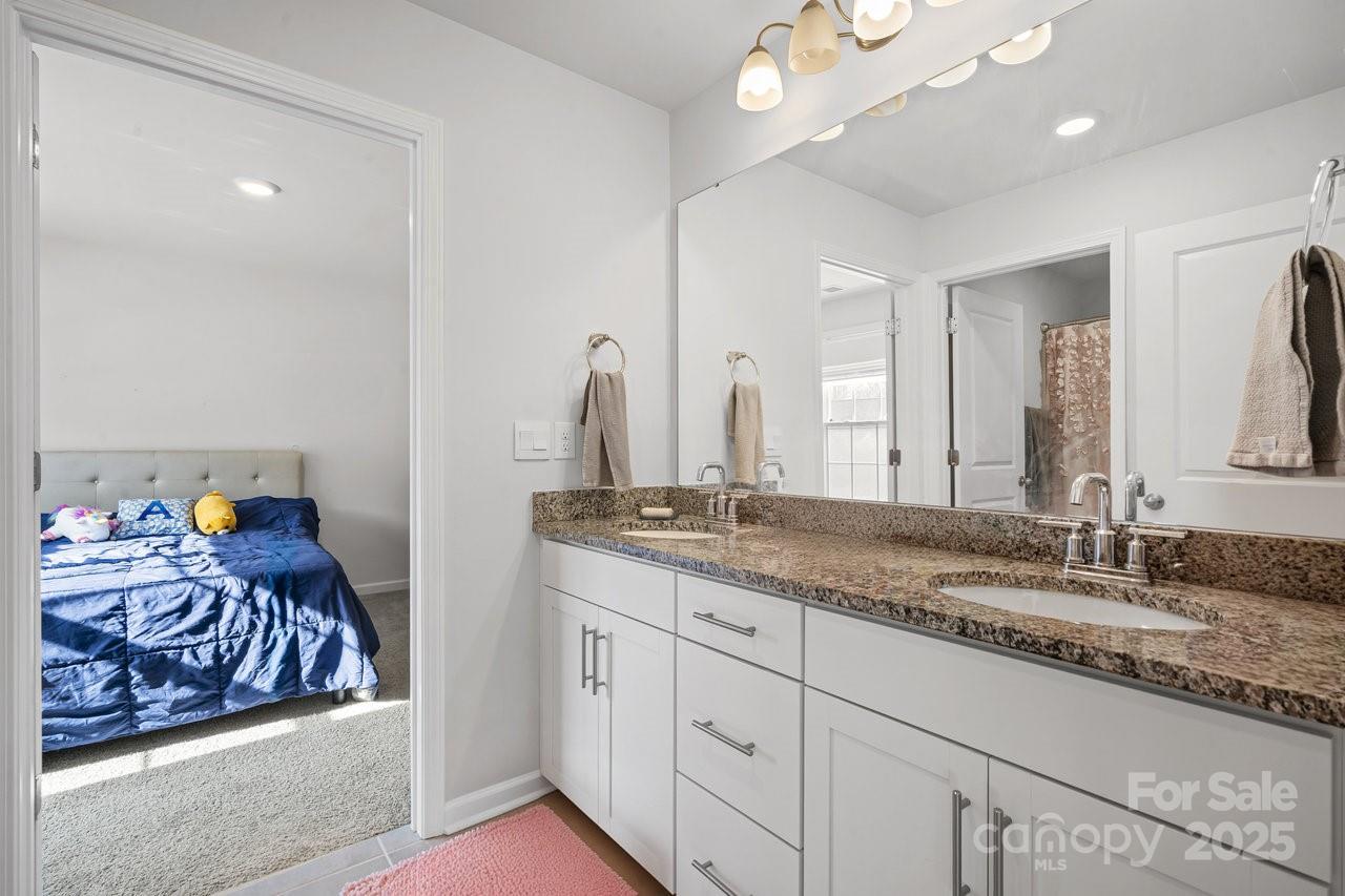 313 Streamwood Road Troutman, NC 28166 - Photo 32 of 48 a bathroom with a granite countertop sink and a mirror