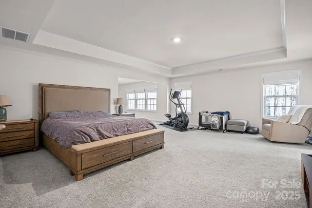 a spacious bedroom with a bed and a couch