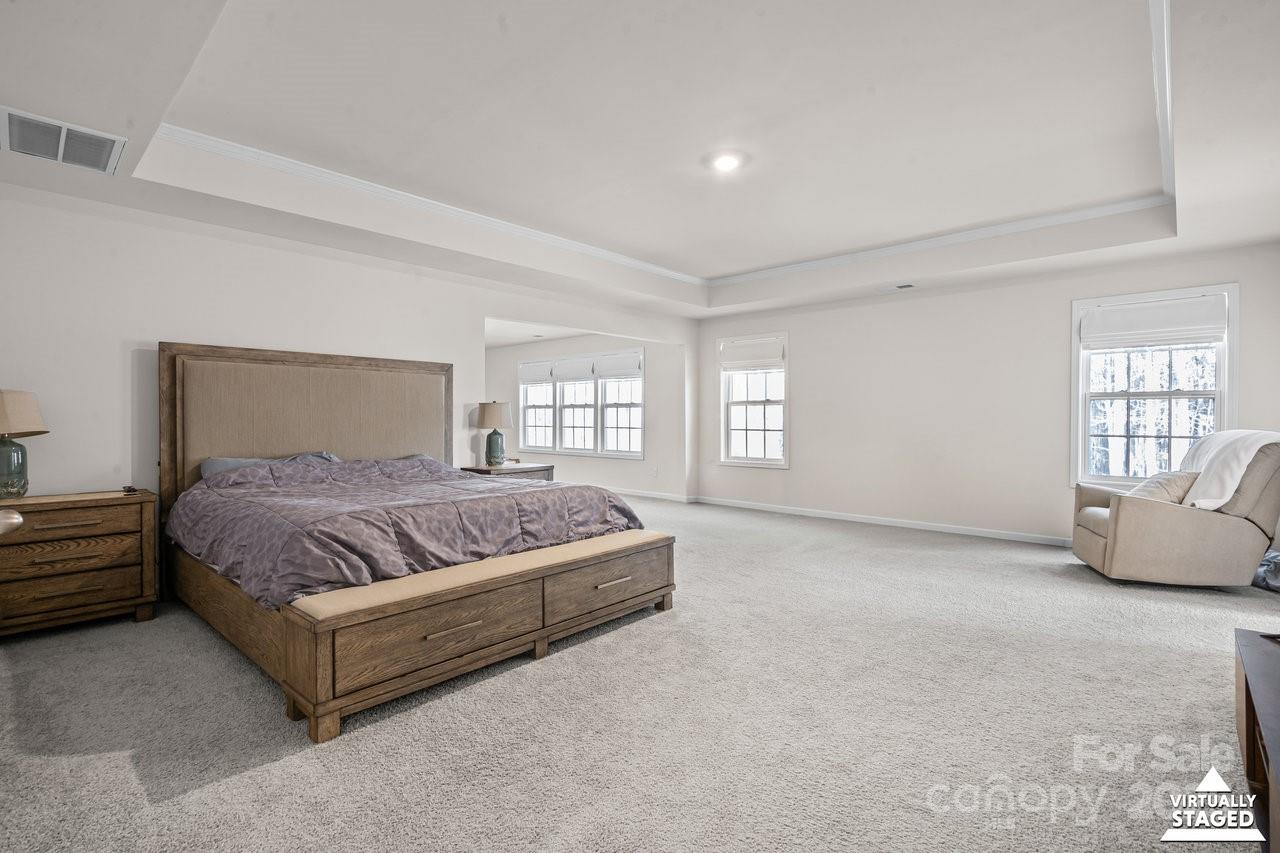 313 Streamwood Road Troutman, NC 28166 - Photo 35 of 48 a spacious bedroom with a bed and glass window