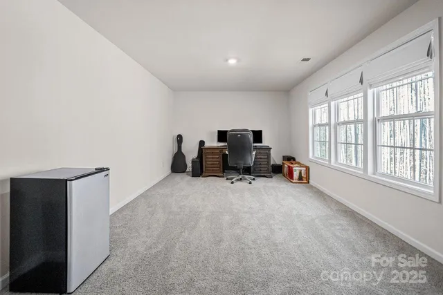a view of a livingroom with workspace and a window