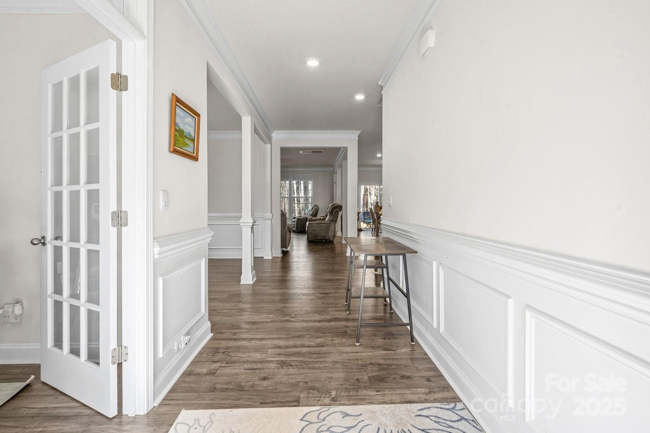 313 Streamwood Road Troutman, NC 28166 - Photo 4 of 48 a view of a hallway with wooden floor and staircase