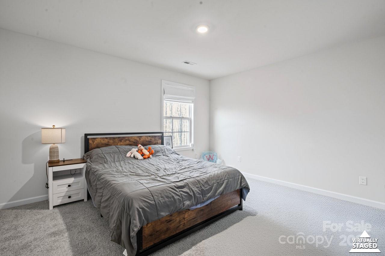 313 Streamwood Road Troutman, NC 28166 - Photo 42 of 48 a bedroom with a bed and a window