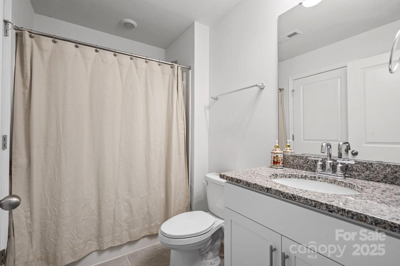 313 Streamwood Road Troutman, NC 28166 - Photo 43 of 48 a bathroom with a granite countertop sink and a mirror
