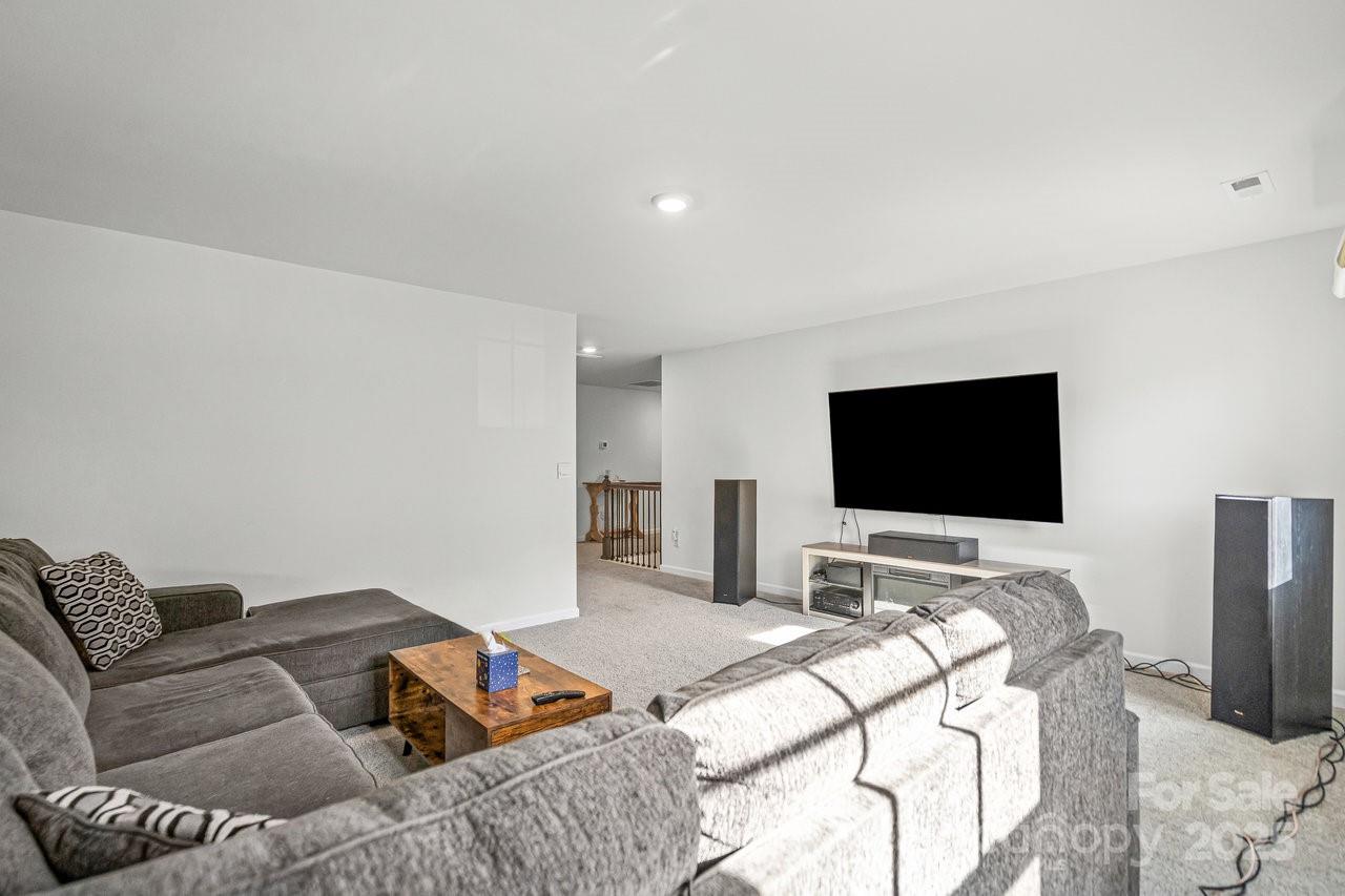 313 Streamwood Road Troutman, NC 28166 - Photo 45 of 48 a bedroom with a bed and a flat screen tv