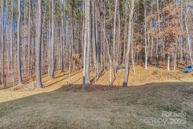 a view of outdoor space with wooden fence