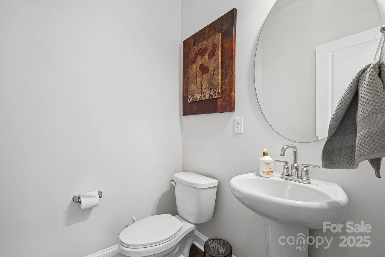 313 Streamwood Road Troutman, NC 28166 - Photo 8 of 48 a bathroom with a toilet a sink and mirror