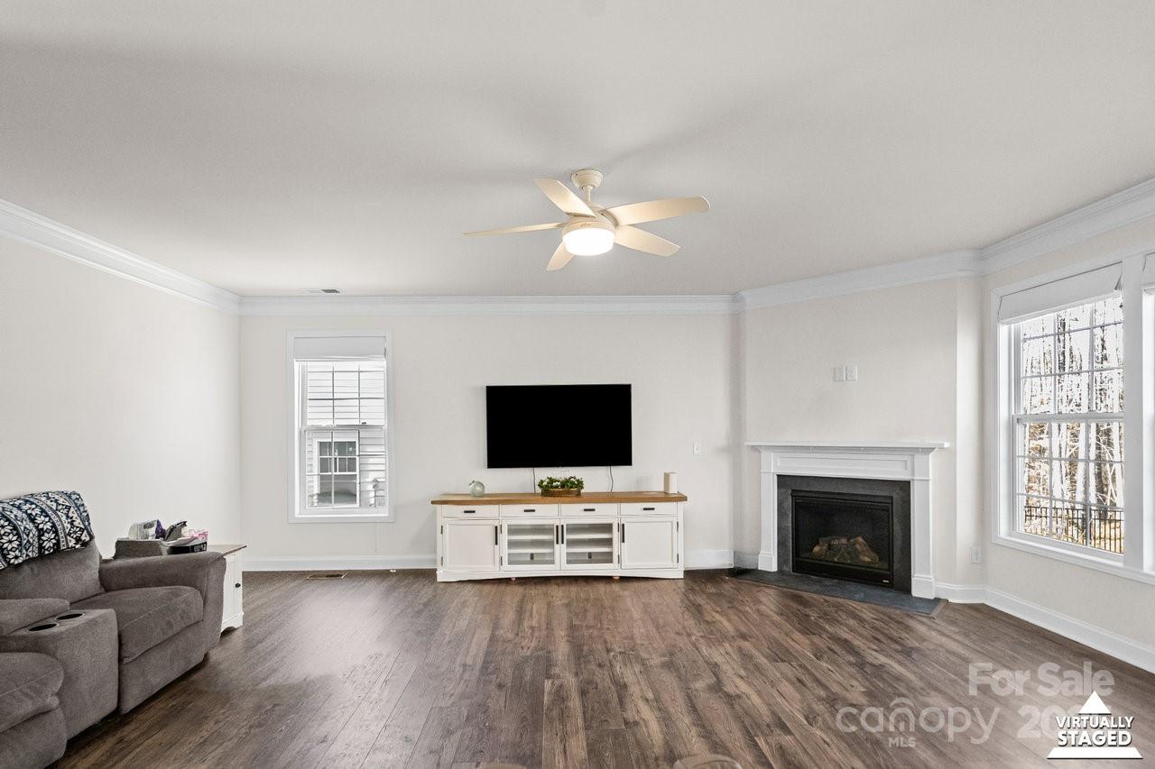 313 Streamwood Road Troutman, NC 28166 - Photo 10 of 48 a living room with furniture and a flat screen tv
