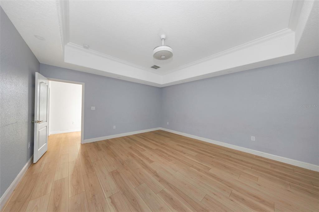 20138 Bowman Road Spring Hill, FL 34610 - Photo 29 of 40 a view of an empty room with wooden floor and a window