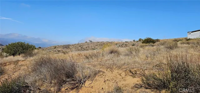 a view of a large building with mountains in the background