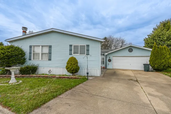 a view of house with backyard and entertaining space